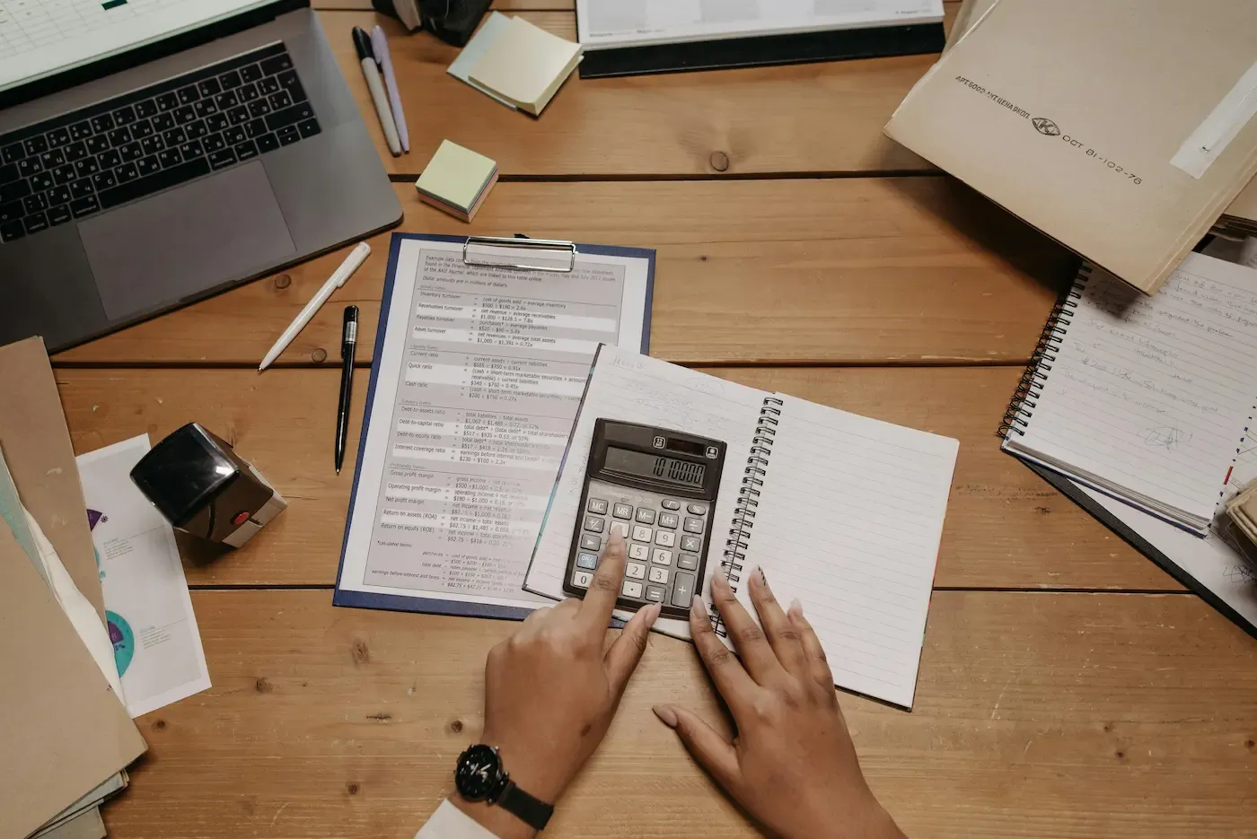 Calculator and paperwork on a desk — child support reduction in Alberta